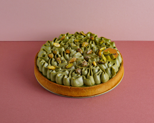 A delightful layered tart featuring a buttery pastry shell filled with a creamy sicilian pistachio filling, garnished with pistachio cream and chopped pistachios for a nutty crunch. The pistachio filling is made from premium sicilian pistachios, known for their exceptional and rich, nutty flavour. This delicious tart is highly recommended for all nut lovers and the elderly. 