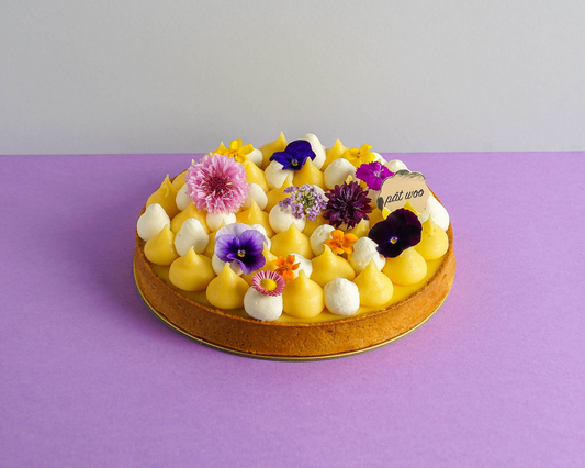 A colourful fruit tart decorated with edible flowers. The little acidic tang in the yuzu makes this flavourful tart not too sweet nor sour. This yuzu tart also comes in many different sizes, which is suitable for large groups or any other special occasions. 